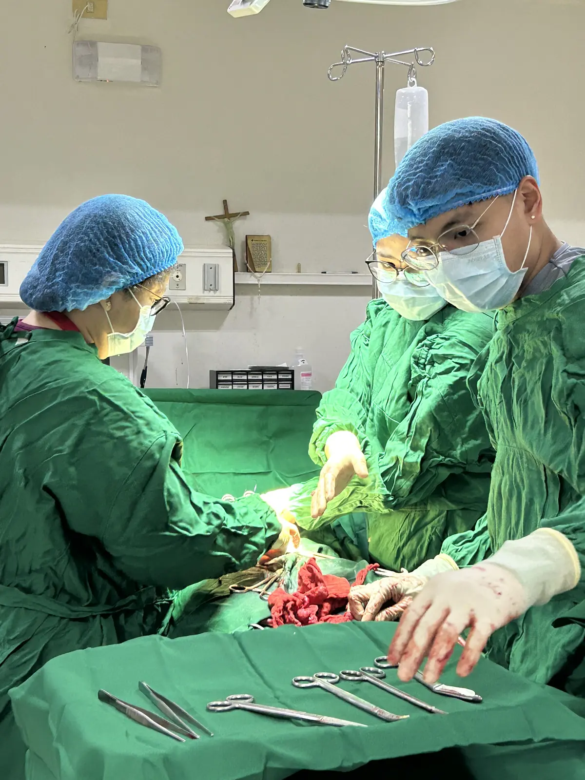 Pio assisting with a surgical procedure in the operating room