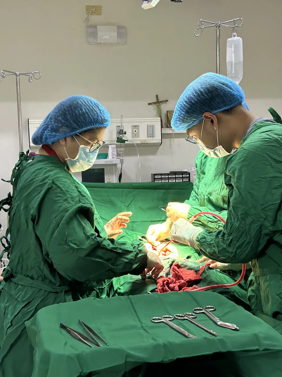 Pio and a colleague working during a surgical procedure