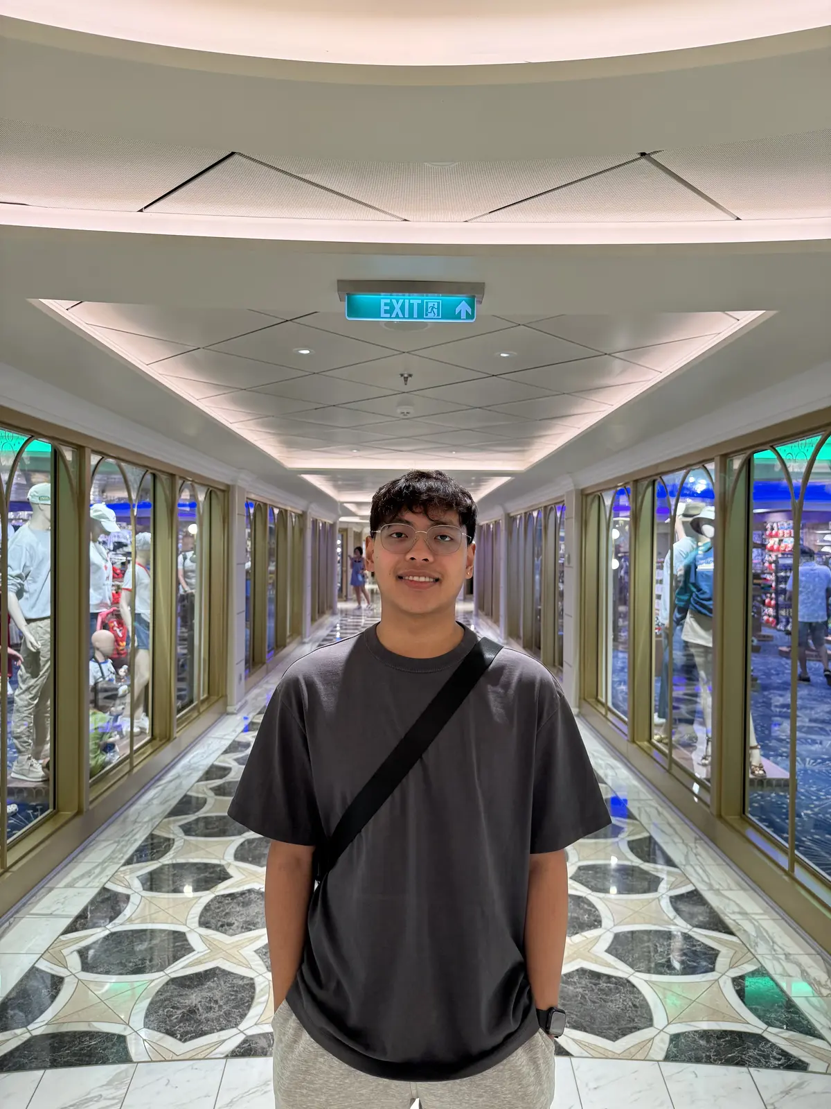Pio standing inside a brightly lit ship corridor